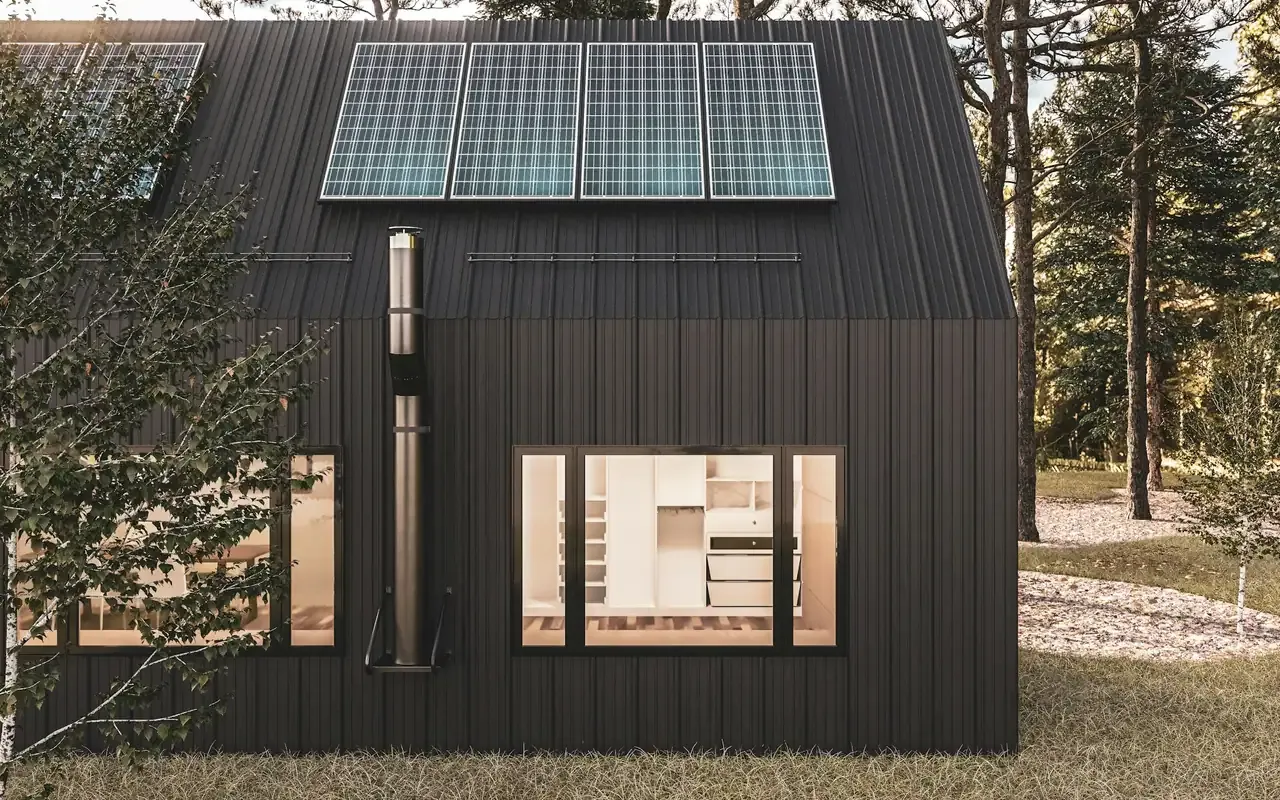 Dark timber house with rooftop solar panels and warmly lit windows at dusk